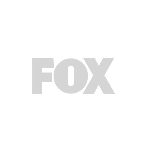 Logo of Fox, featuring the word 'FOX' in a bold, stylized font. The logo is presented in a light gray color on a white background.